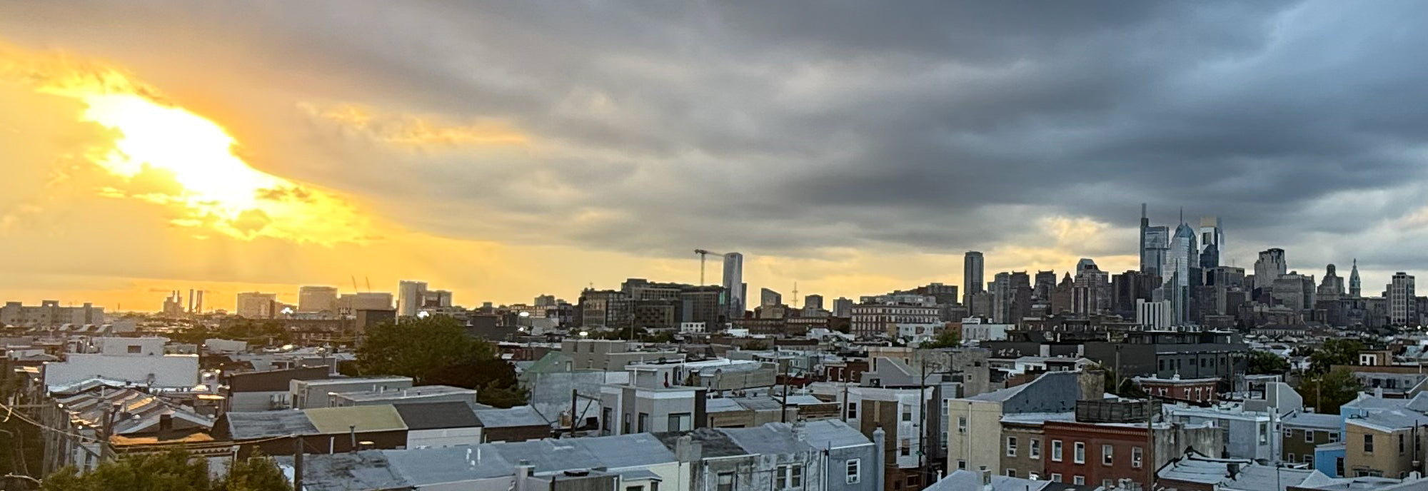 Philadelphia skyline at sunset viewed from a South Philadelphia rooftop above Earp Street